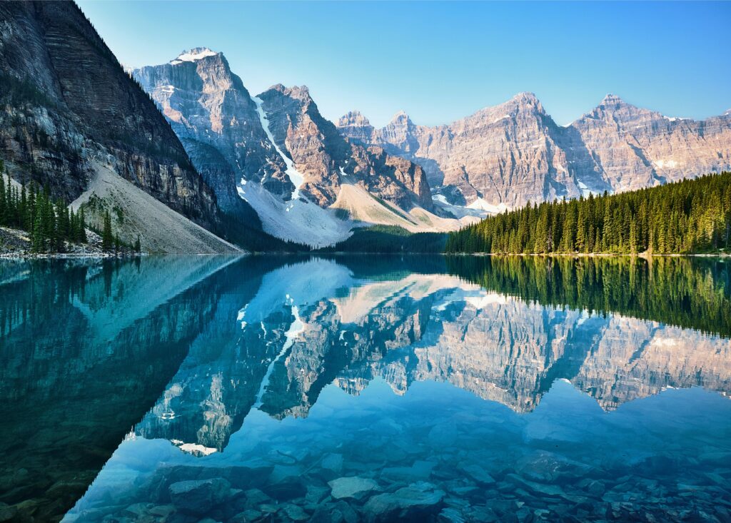 Lake Louise stuns visitors with its vibrant turquoise water reflecting the majestic glacier-capped mountains. Canoeing on this famed lake offers a chance to be surrounded by breathtaking scenery.
